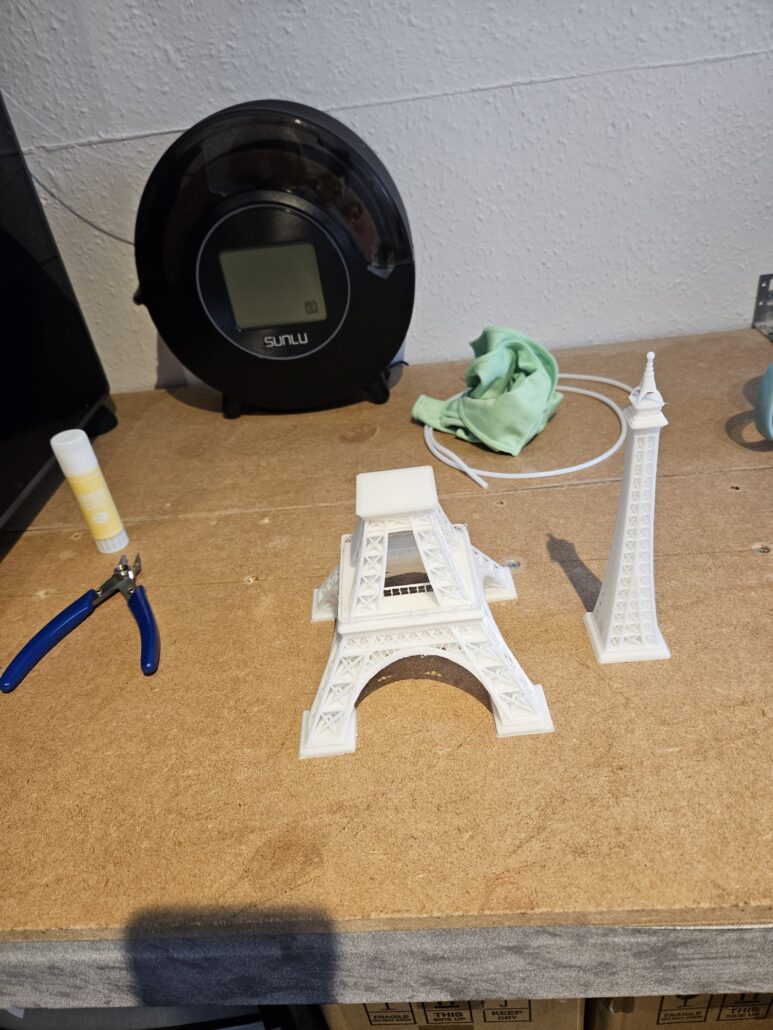 Eiffel Tower model displayed in two parts in white filament